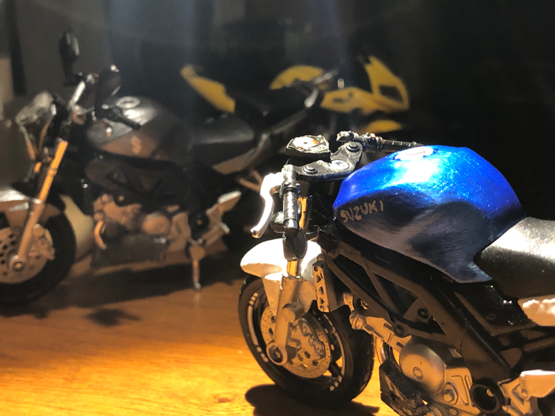 Seen here is the 2003 SUZUKI letters on the fuel tank, which changed to the stylized S logo on 2004 and later SV models. You may be saying, hey, I thought all 2003-2004 SV models had silver frames! You would be right, but Ethan painted his black. My radiator is also black where the ends of his are silver.
